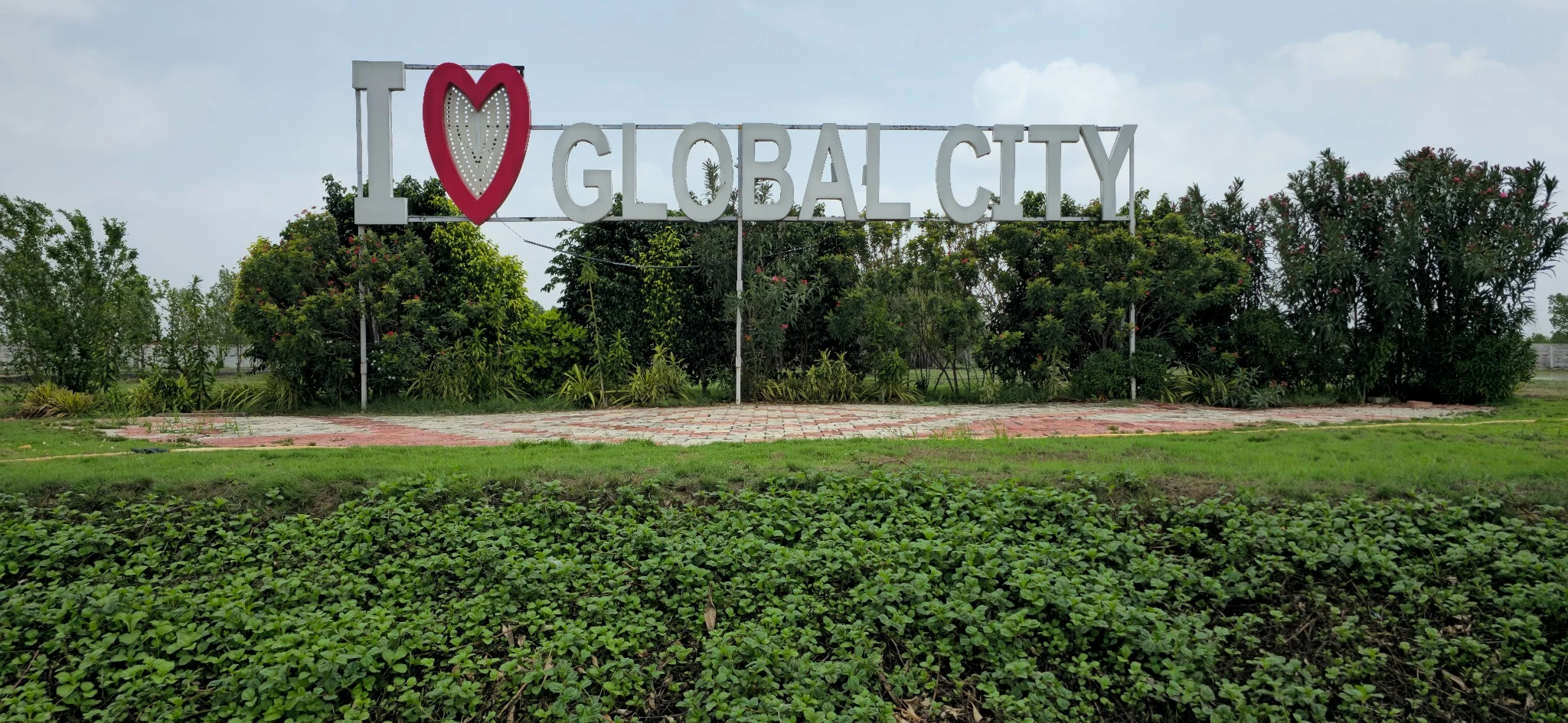 The I love Global City sign photographed from the front, surrounded by greenery
